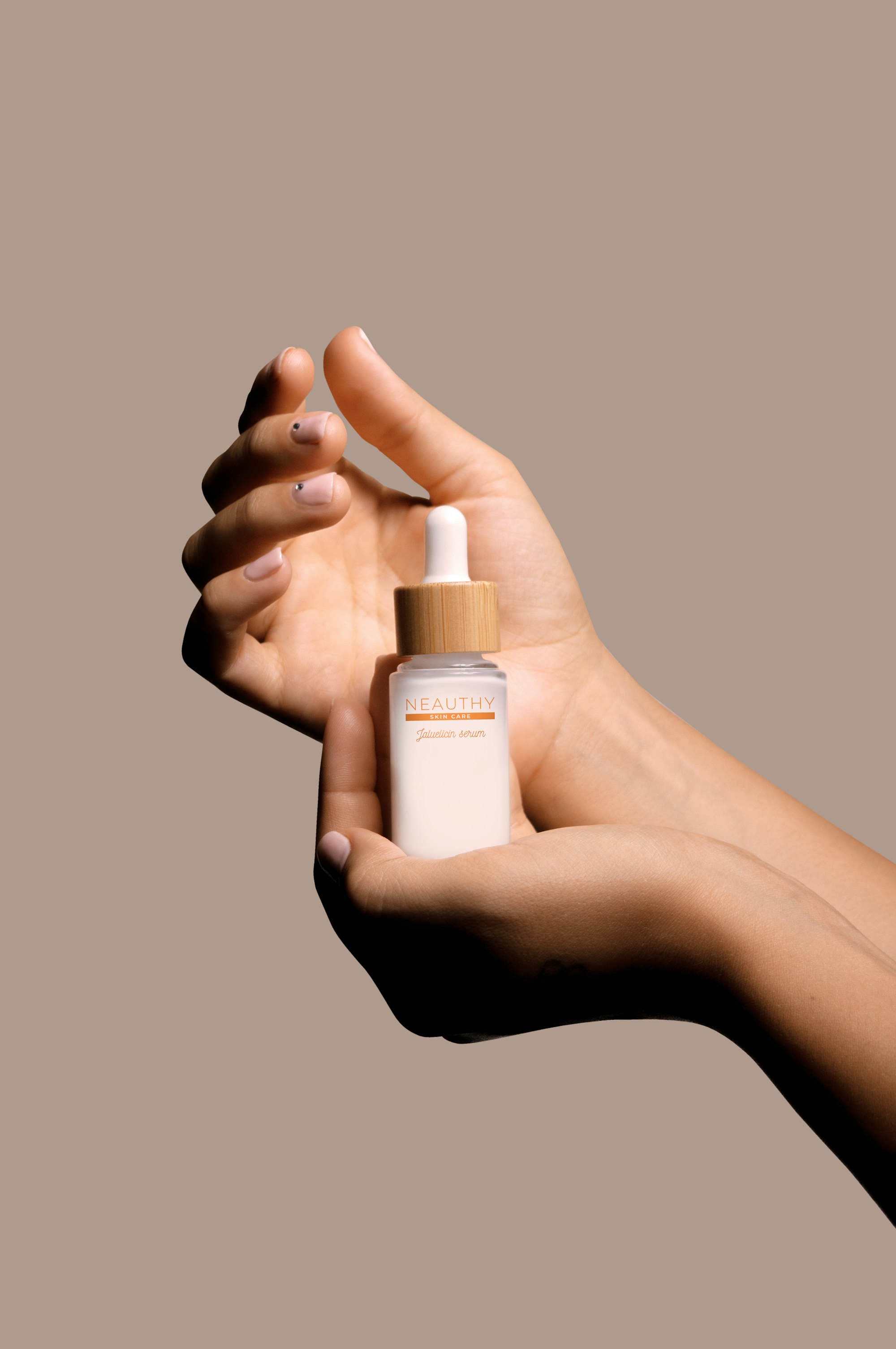 Hands holding a skincare bottle
