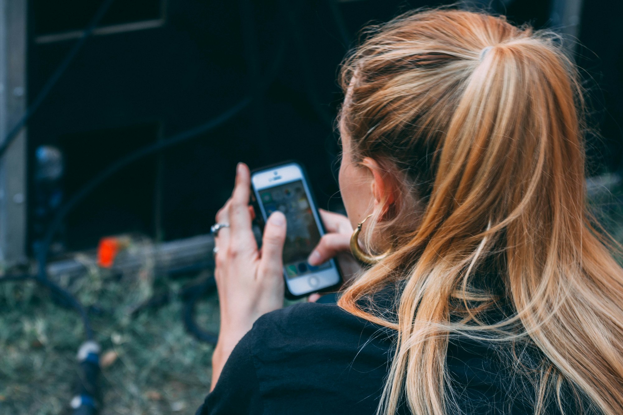 A creator filming on her phone outdoors